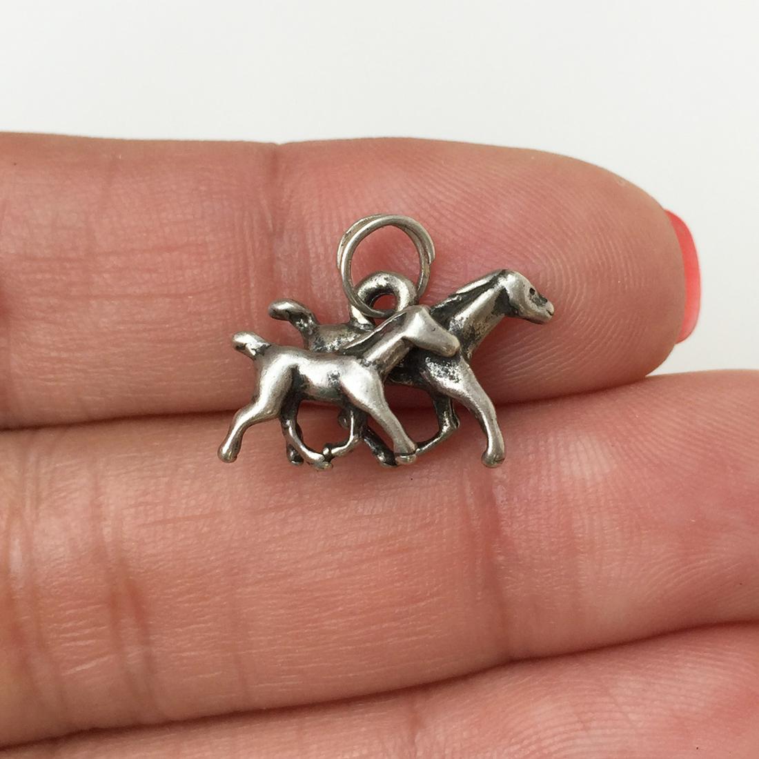 Sterling silver 2 Horses running charm pendant: Sterling silver 2 Horses running charm pendant. Weight 1.94 grams. No hallmark, tested 925. Length 1/2 inches with bail. Condition very good.