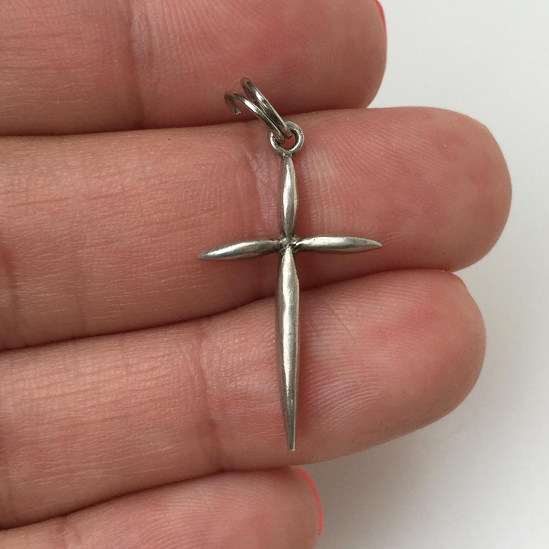 Sterling silver Cross charm pendant: Sterling silver Cross charm pendant. Weight 1.25 grams. Hallmarked 925. Length 1 1/4 inches with bail. Condition very good.