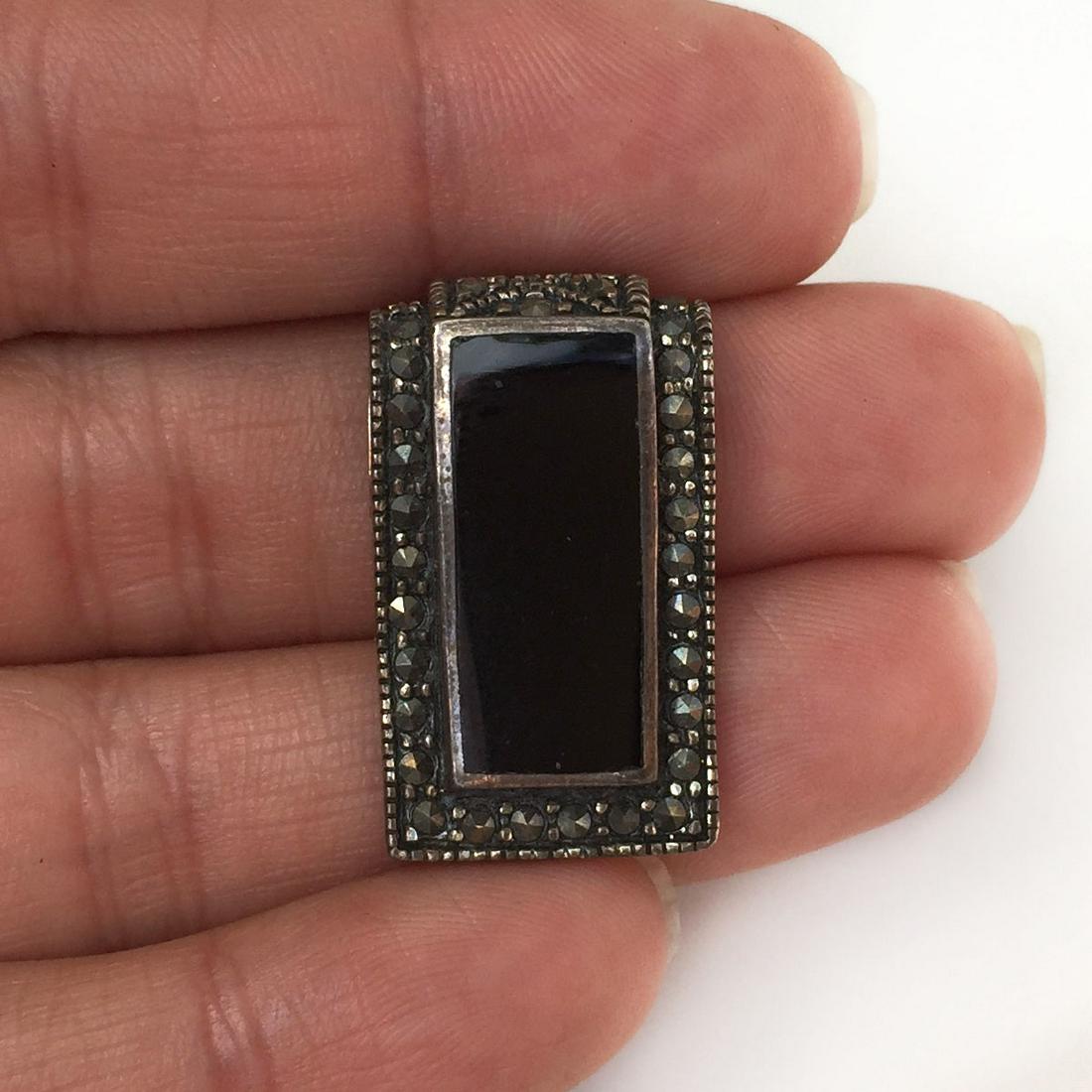 Sterling silver marcasites black onyx pendant: Sterling silver marcasites black onyx pendant. Weight 4.93 grams. Hallmarked FAS 925. Length 1 inch. Condition excellent.