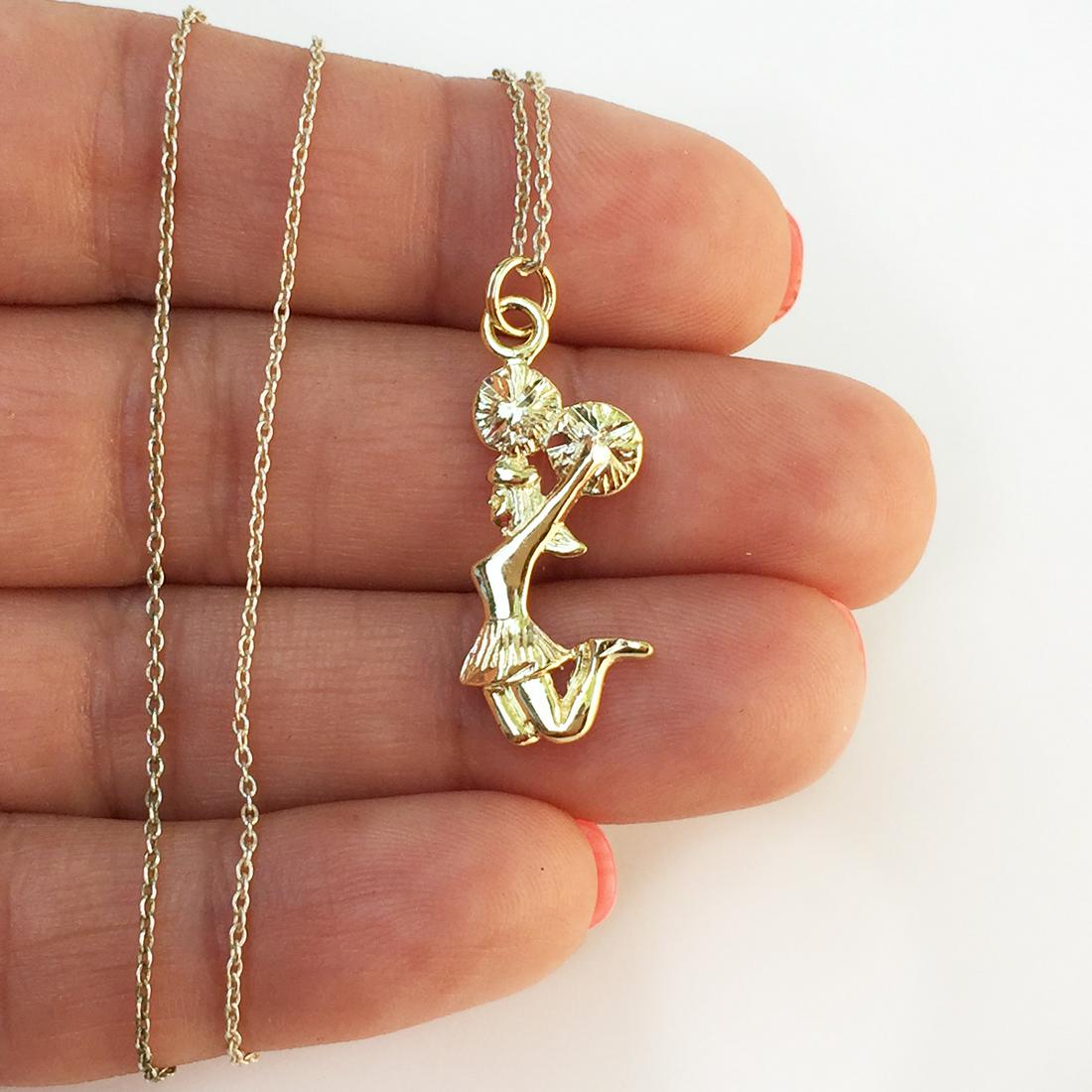 Gold plated sterling silver Cheerleader pendant chain: Gold plated sterling silver Cheerleader with Pom Poms pendant charm and chain. Weight 2.22 grams. Pendant hallmarked Thai, 925 SU. Chain hallmarked 925 ITALY. Pendant length 1 1/8 inches with bail. Ch