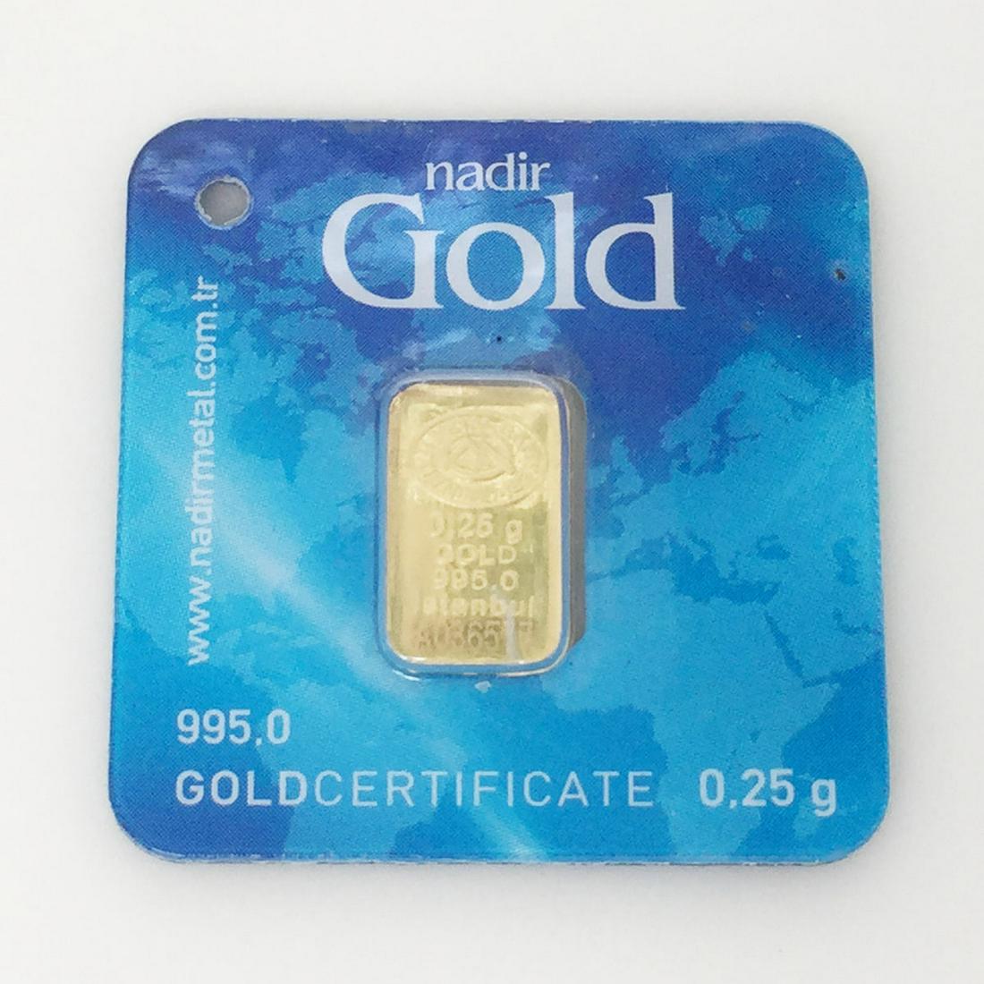 995.0 gold bar bullion 0.25 gram by NADIR GOLD: Collectible 995.0 gold bar bullion 0.25 gram produced by NADIR GOLD. Bar is sealed in it's own card and has its weight, Purity and unique individual number lasered on to the Gold bar.