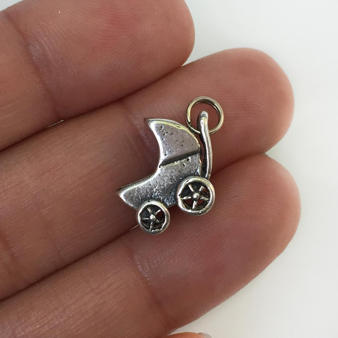Vintage sterling silver baby stroller carriage charm: Vintage sterling silver baby stroller carriage charm. Weight 2.14 grams. No hallmark, tested 925. Length 3/4 inches with bail. Condition very good.