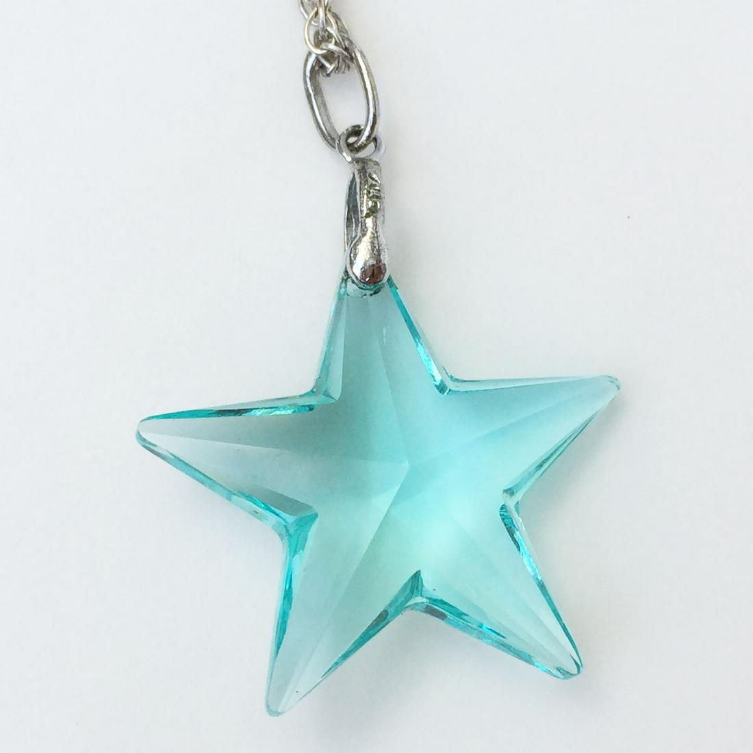 Silver Aqua Blue Star crystal pendant: Silver Aqua Blue Star crystal pendant. Pendant length 1 1/2 inches with bail. No hallmark, pendant top and bail tested 800. Star has a tiny engraved ladder or tower inside its top peak. Condition exce