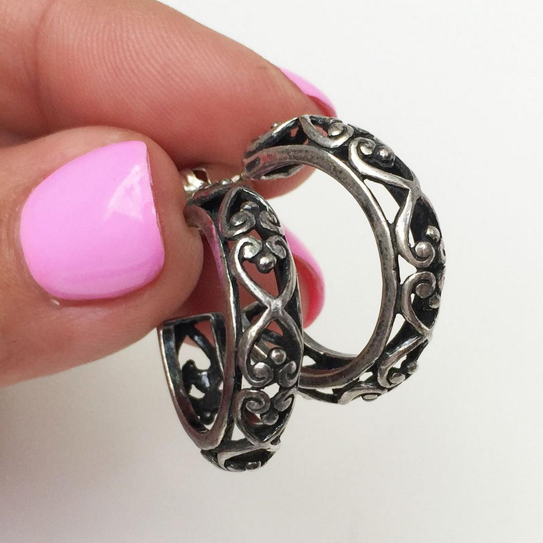 Sterling silver heart swirl huggie hoop earrings: Sterling silver heart swirl huggie hoop push back earrings. Weight 5.18 grams. No hallmark, tested 925. Length 7/8 inches. Condition excellent.