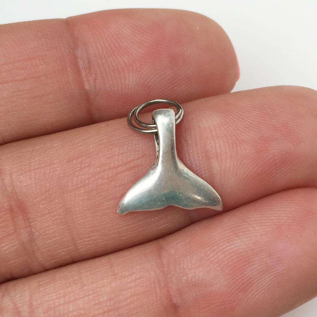 Sterling silver Whale Tail charm pendant: Sterling silver Whale Tail charm pendant. Weight 0.88 grams. Hallmarked LEX 925. Length 3/4 inches with bail. Condition very good.