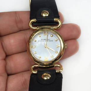 MARC by MARC JACOBS ladies gold tone leather watch: MARC by MARC JACOBS ladies gold tone black leather watch. Stainless steel case back, MBM109 251407, Water resistant 5 ATM. Watch is working, needs batteries. Condition very good.