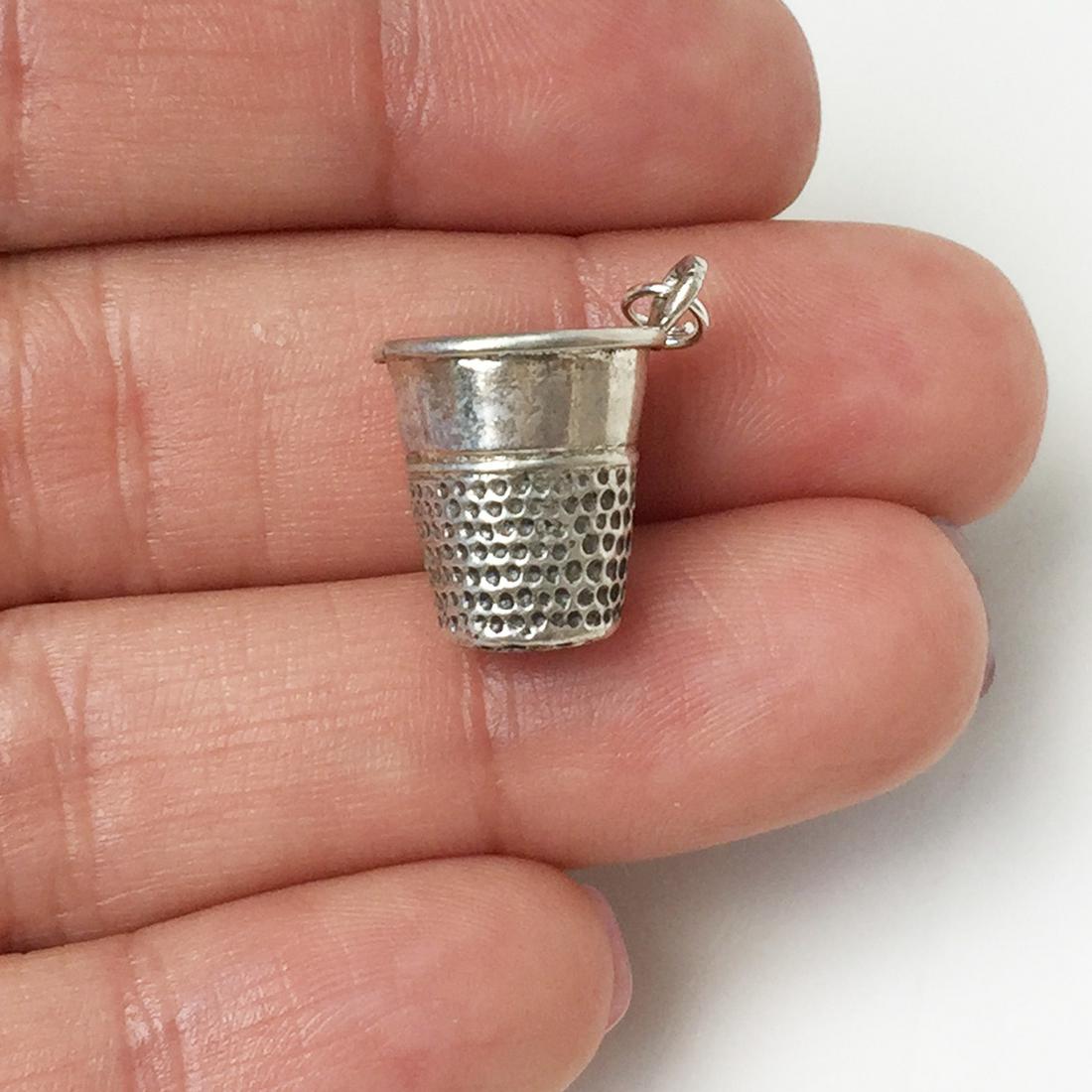 Sterling sliver Thimble shape charm pendant: Sterling sliver Thimble shape charm pendant. Weight 2.61 grams. No hallmark, tested 925. Length 3/4 inches with bail. Condition very good.