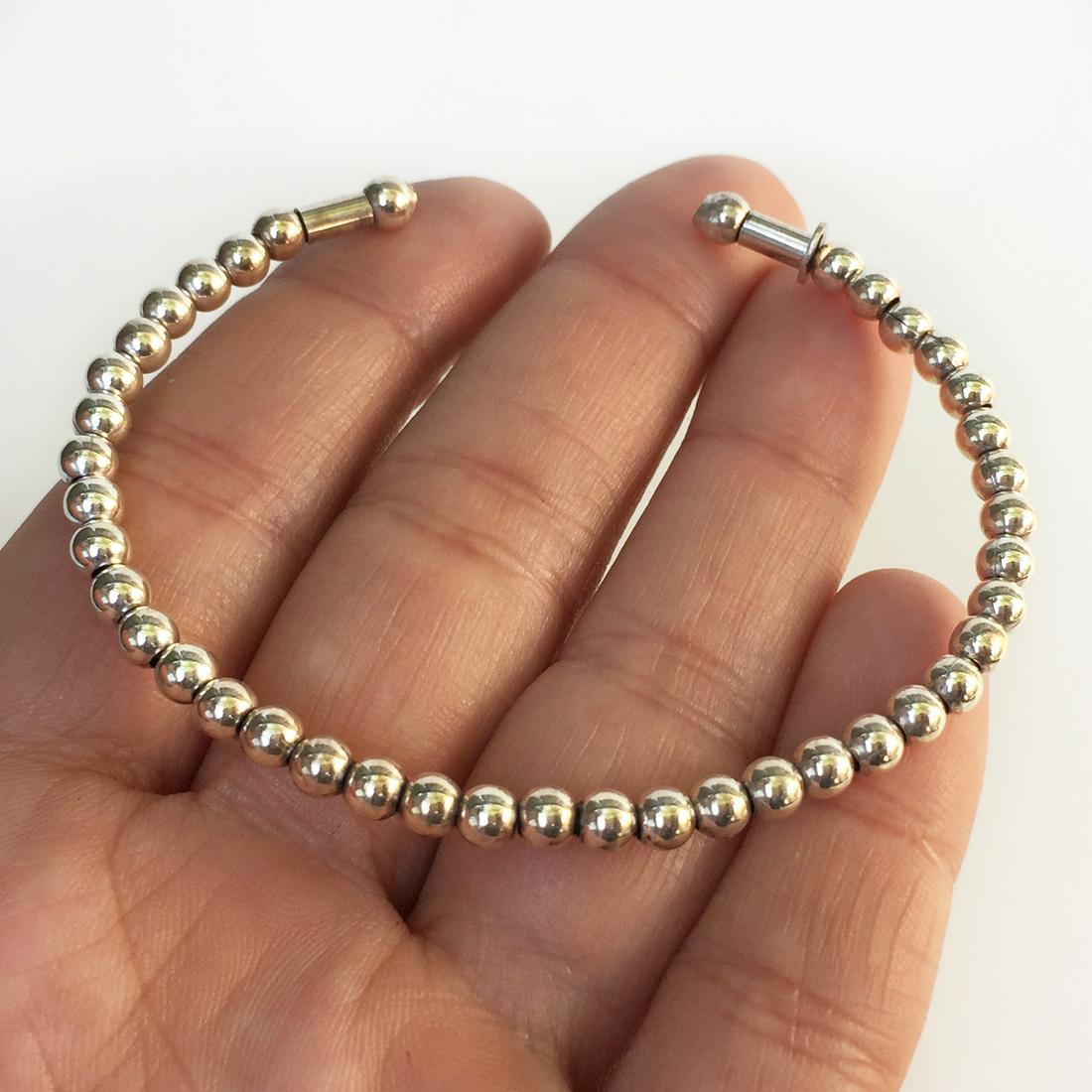 Sterling silver round beads cuff bracelet: Sterling silver round beads cuff bracelet. Weight 6.78 grams. Hallmarked Italy 925. Beads measured 4 mm in diameter. Condition very good.