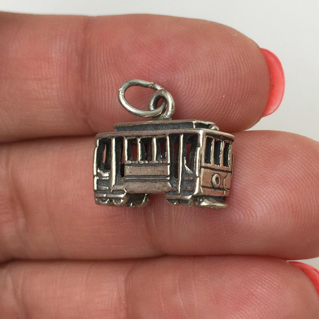 Sterling silver Cable car Trolley charm pendant: Sterling silver Cable car Trolley charm pendant. Weight 2.80 grams. No hallmark, tested 925. Length 5/8 inches with bail. Condition excellent.