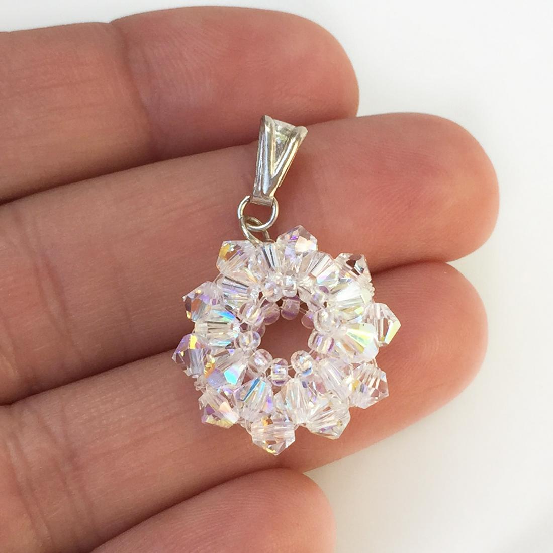 Sterling silver iridescent faceted beads flower pendant: Sterling silver iridescent faceted beads flower pendant. Length 1 1/8 inches with bail. Bail is hallmarked 925. Condition very good.
