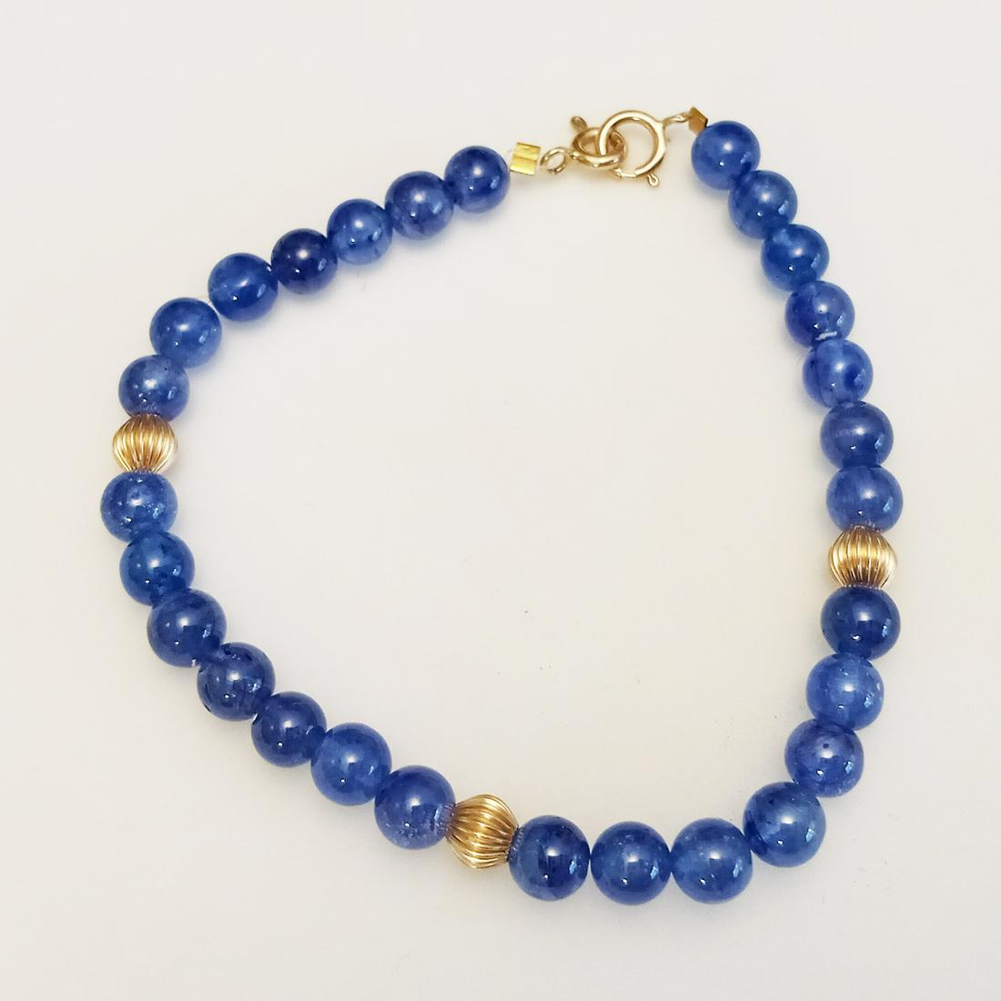 Sapphire, 14k yellow gold beads, clasp bracelet: Genuine round blue sapphire, 14k yellow gold round beads bracelet with 14k gold spring ring clasp. Gold round beads measured 4.4 mm, blue sapphire beads approximately 5 mm in diameter each. Length 7 1