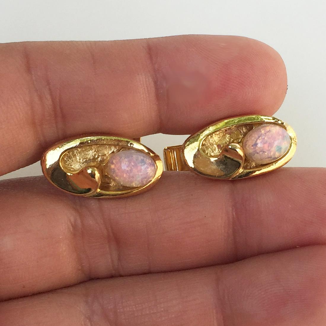 Vintage gold tone opal color cabochon cufflinks: Vintage gold tone opal color cabochon oval shape cufflinks. Measured 3/4 x 3/8 inches. Condition very good. Hallmarked PAT 2,974,381