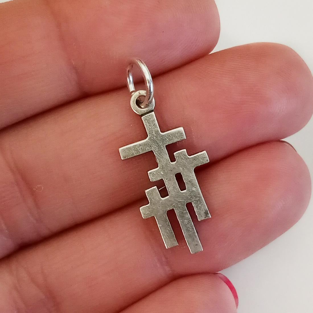 Sterling silver triple Cross pendant: Sterling silver triple Cross pendant. Weight 1.56 grams. Length 1 inch with bail. Hallmarked STER ©91. Condition very good.