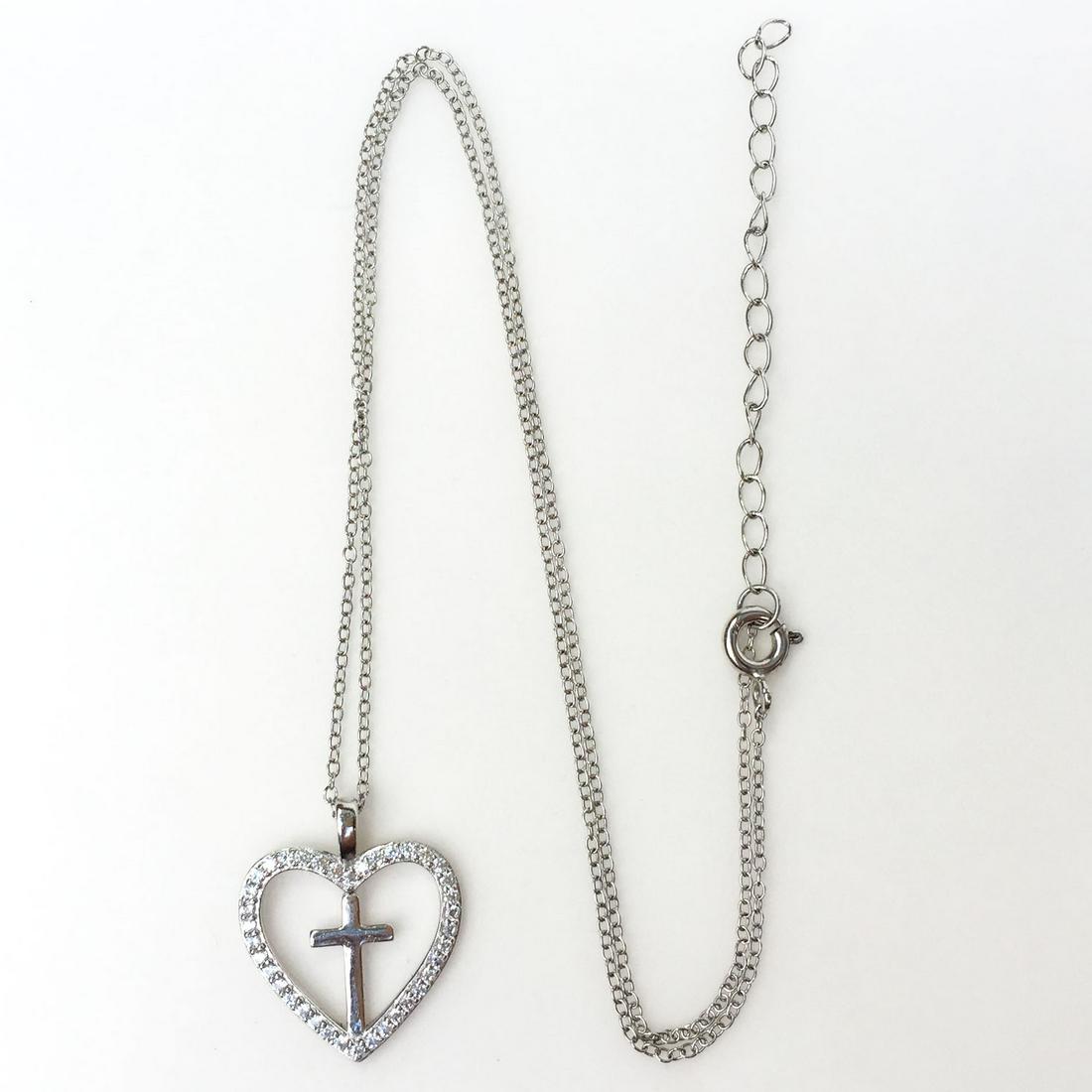 Sterling silver Cross heart CZ pendant with chain: Sterling silver Cross heart CZ pendant with chain. Weight 2.41 grams. Hallmarked 925. Pendant length 1 inch with bail, chain length 16 inches + 2 inches extender. Condition excellent.