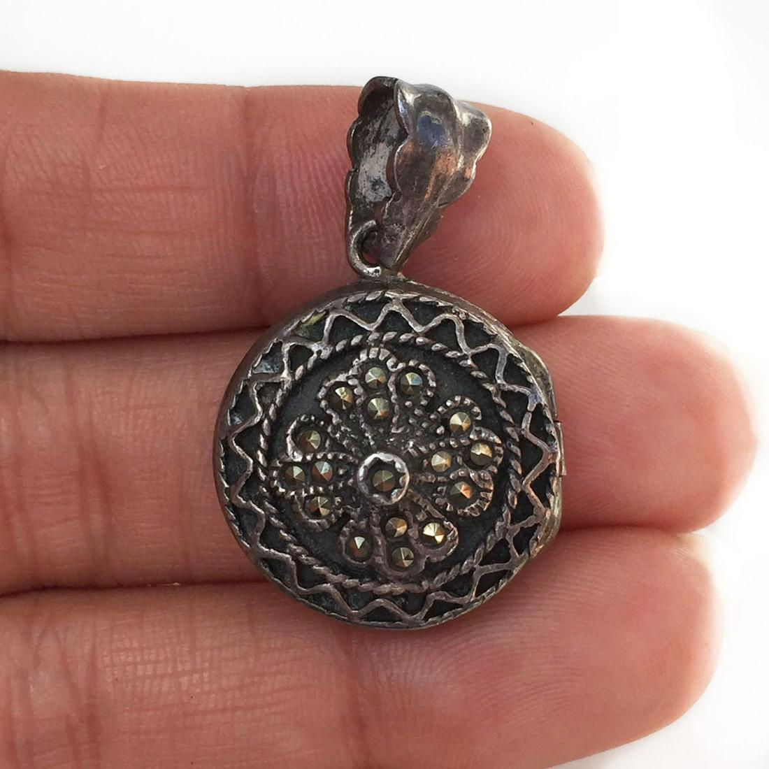 Vintage sterling silver marcasites round locket pendant: Vintage sterling silver marcasites round locket pendant. Weight 12 grams. Hallmarked 925. Length 1 1/4 inches. Condition excellent.