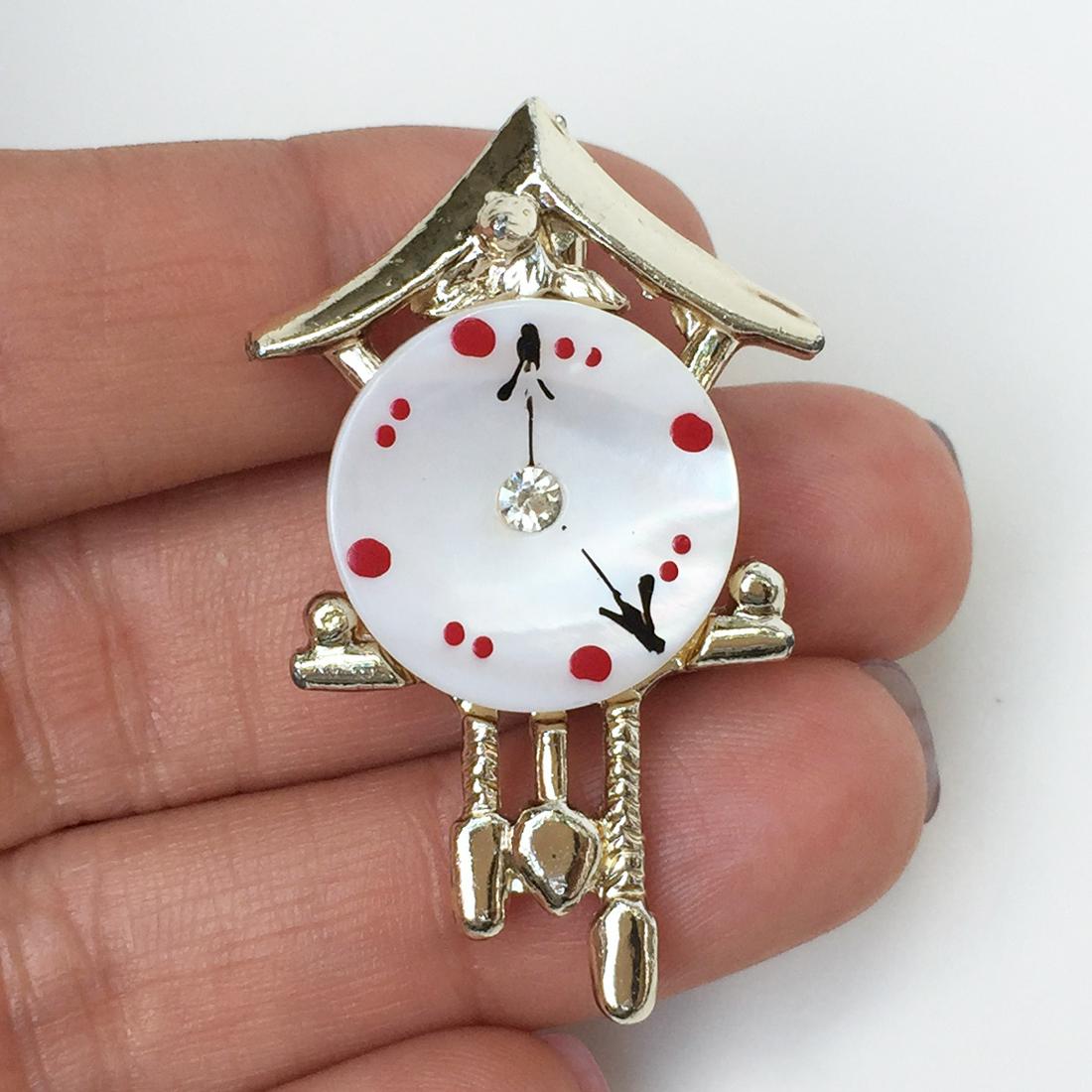 Gold tone crystals iridescent Cuckoo clock brooch: Gold tone crystals iridescent Cuckoo clock brooch. Measured 1 3/4 x 1 1/8 inches. Condition excellent.