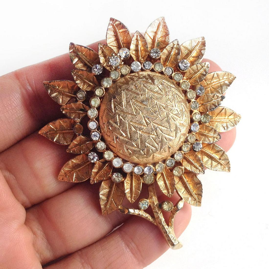 CORO Vintage gold tone Sunflower Brooch Watch, signed: CORO: Vintage gold tone Sunflower Flower Brooch Watch with clear crystals, signed. Hallmarked Coro ©. Measured 2 5/8 x 2 1/4 inches. Hidden inside is a watch placed upside down in the brooch so as to
