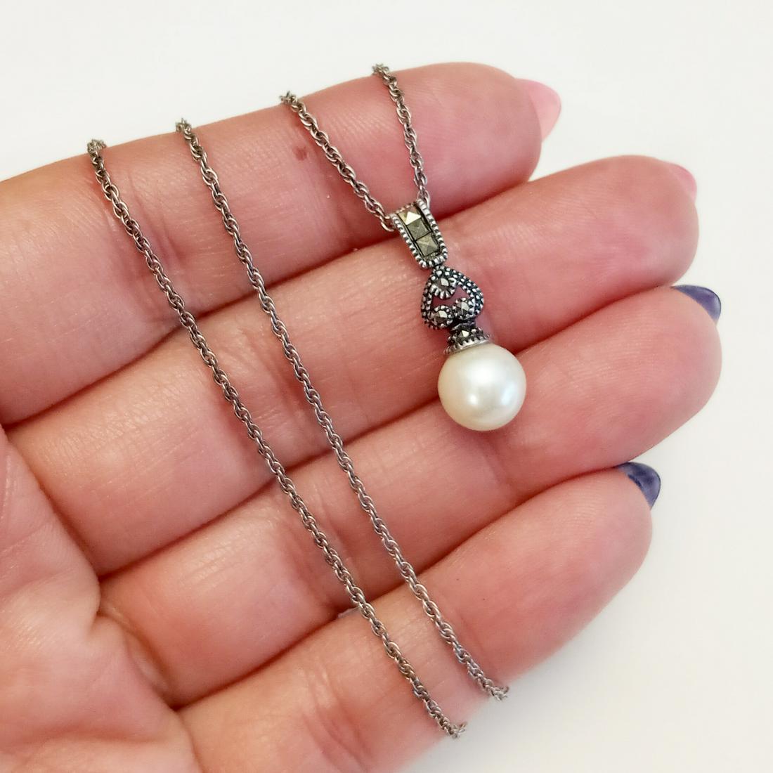 JJ Sterling silver marcasites, faux pearl pendant chain: JUDITH JACK Sterling silver marcasites, white faux pearl pendant and twisted rope chain. Weight 3.08 grams. Chain length 16 inches, hallmarked 925, JJ in rombus. Faux pearl is measured approximately 7