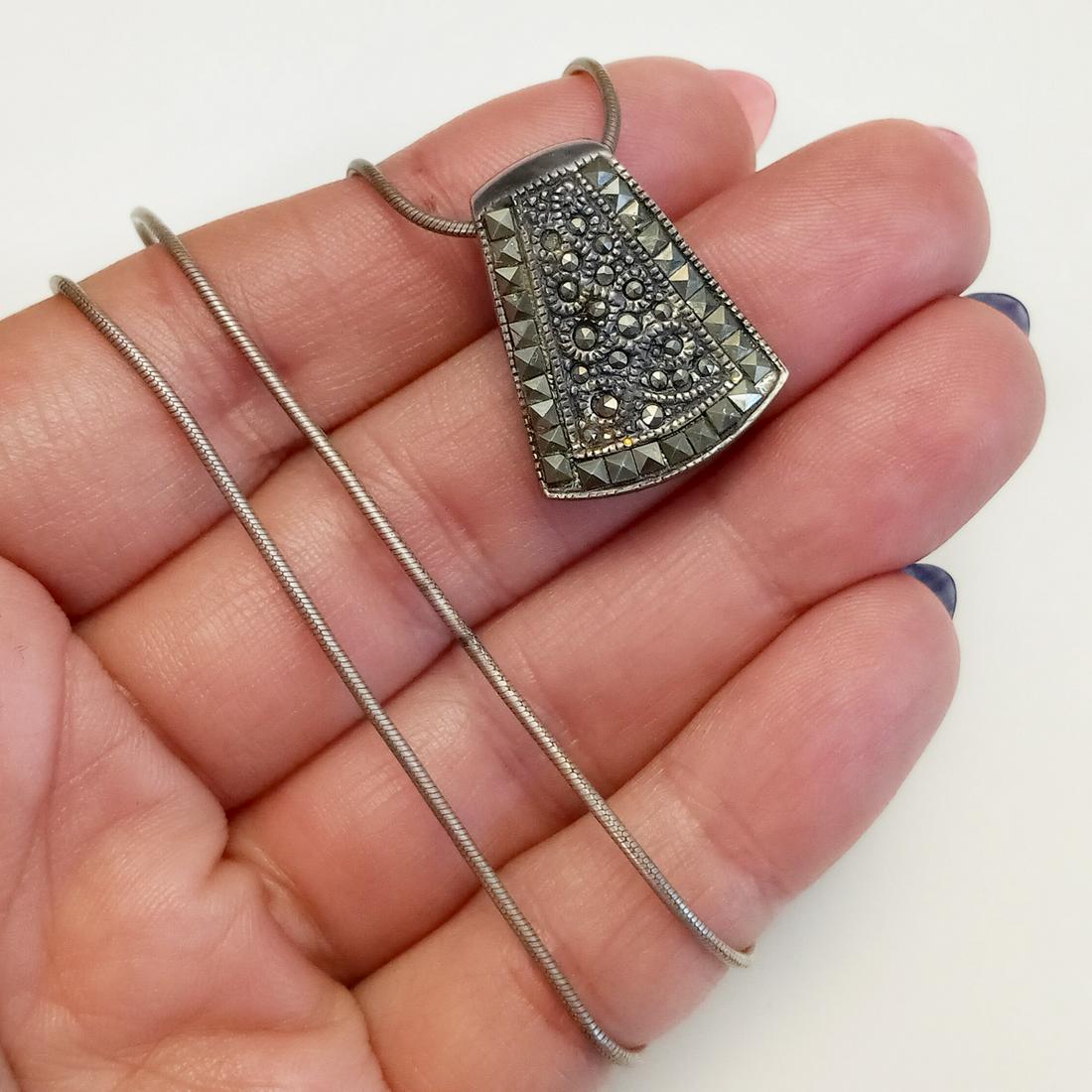 Sterling silver marcasited pendant snake chain: Oxidized sterling silver marcasited pendant and snake chain. Weight 9.13 grams. Chain length 17 inches, hallmarked 925 Italy. Pendant length 7/8 inches, hallmarked NF 925. Condition good.