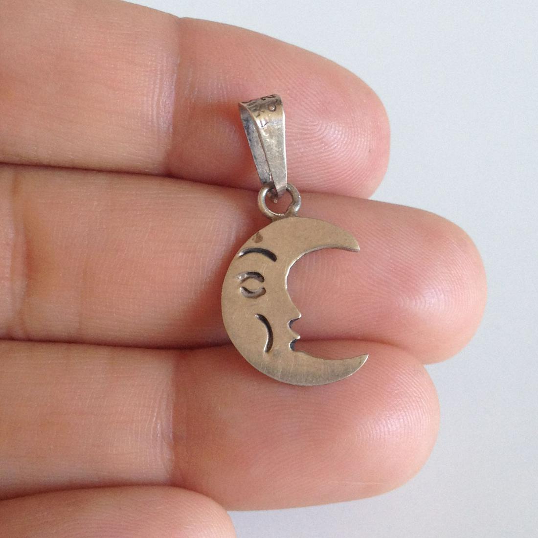 Sterling silver Half Moon Crescent Face pendant charm: Sterling silver Half Moon Crescent Face pendant charm. Weight 1.02 grams. Hallmark 925. Length 1 1/8 inches with bail. Condition very good.