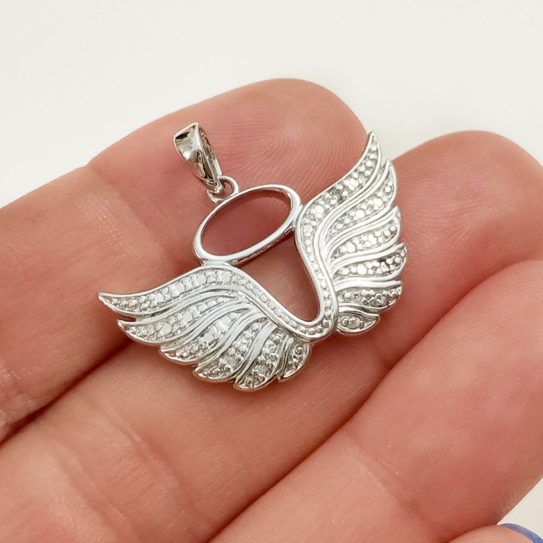 Sterling silver diamond Angel wings Halo pendant: Sterling silver diamond Angel wings Halo pendant. Weight 2.98 grams. Length 7/8 inches with bail. Hallmarked R 925 China. Condition very good.