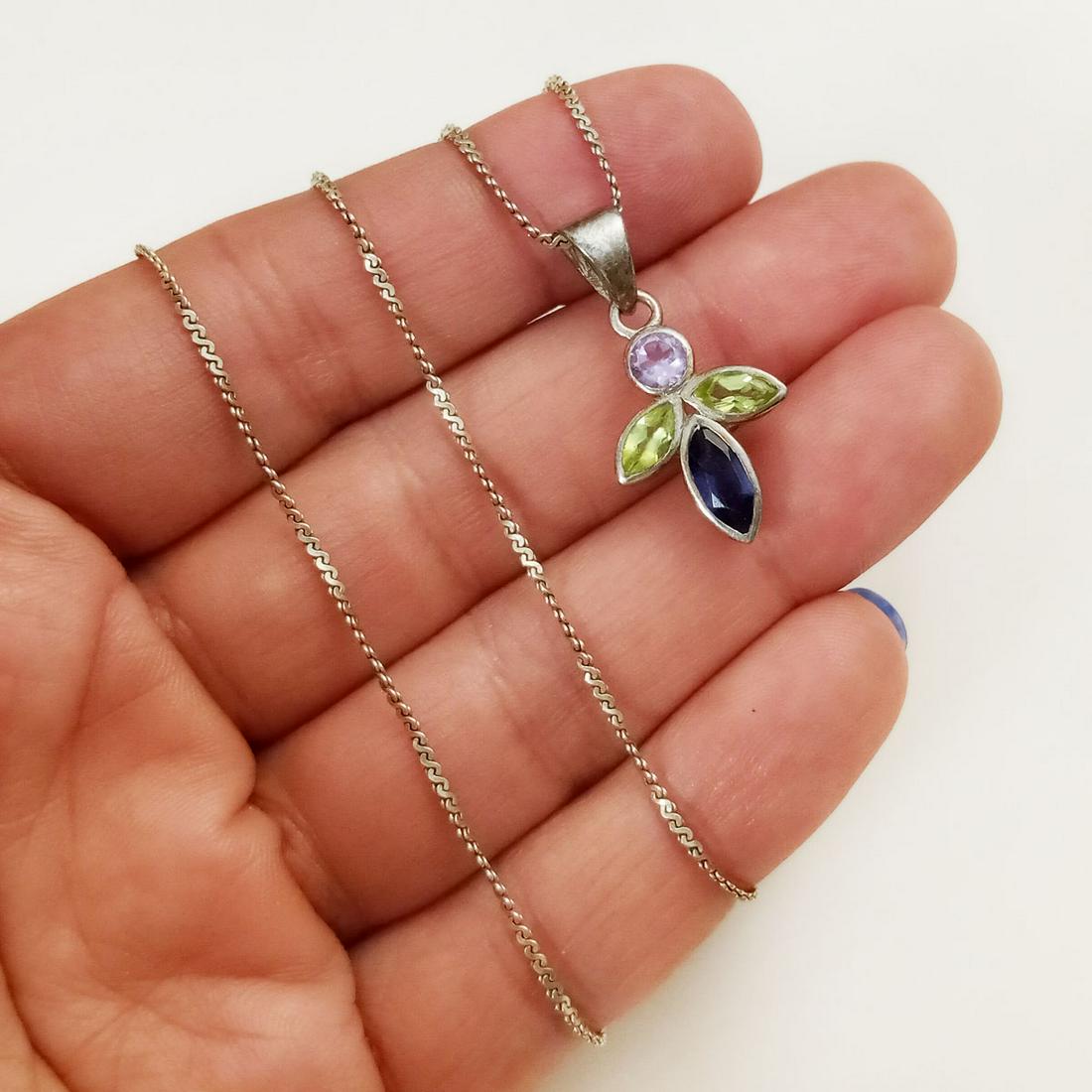 Sterling silver peridot iolite amethyst Angel necklace: Vintage sterling silver faceted peridot, amethyst, iolite Angel shape pendant and fancy chain necklace. Weight 4.56 grams. Pendant length 1 1/8 inches with bail, chain length 19 inches. Hallmarked 925