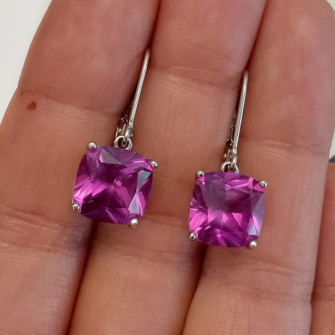 Sterling silver cushion raspberry topaz earrings: Sterling silver cushion shape faceted raspberry topaz lever back earrings. Weight 4.81 grams. Length 1 1/8 inches. Topaz measured approximately 10 x 10 mm. Hallmarked Y in circle, 925 China. Condition