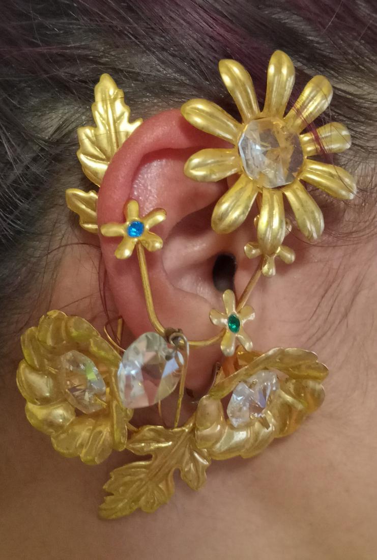 Vintage gold tone Ear Wrap Cuff over the ear jewelry: Vintage gold tone Ear Wrap Cuff over the ear jewelry with green emerald color, red ruby color, blue sapphire color and clear crystals. Measured 4 1/2 x 2 1/2 inches. Condition very good.
