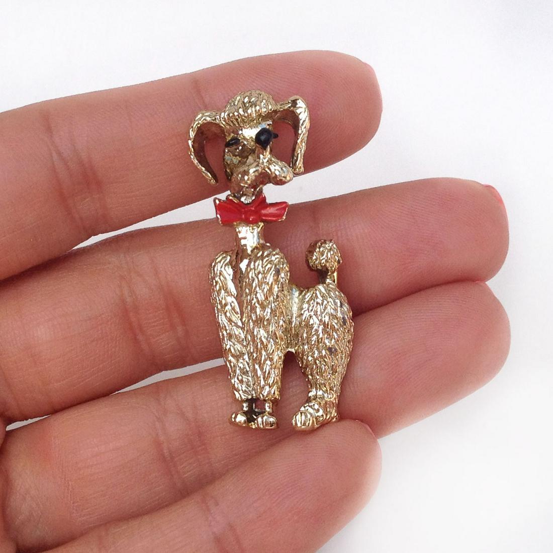 Gold tone Poodle Dog with Bow enamel brooch: Gold tone Poodle Dog with Bow enamel brooch. Measured 1 3/4 x 5/8 inches. Condition Condition very good.