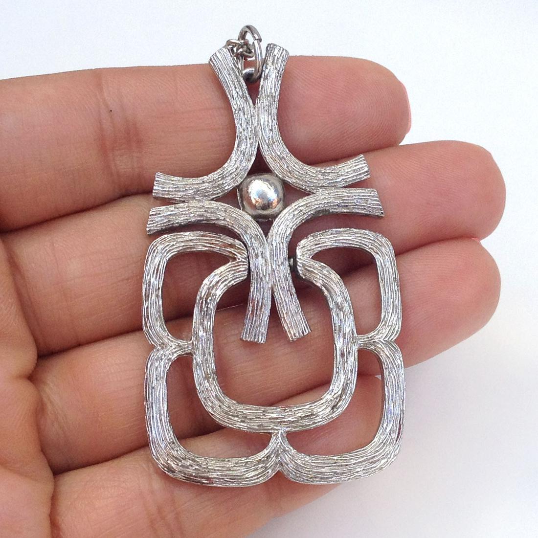 AVON Silver tone textured pendant with chain, signed: AVON Silver tone textured pendant with chain, signed. Hallmarked Avon on pendant. Chain length 30 inches + 4 inches extender. Pendant length 2 1/2 inches with bail. Condition very good.