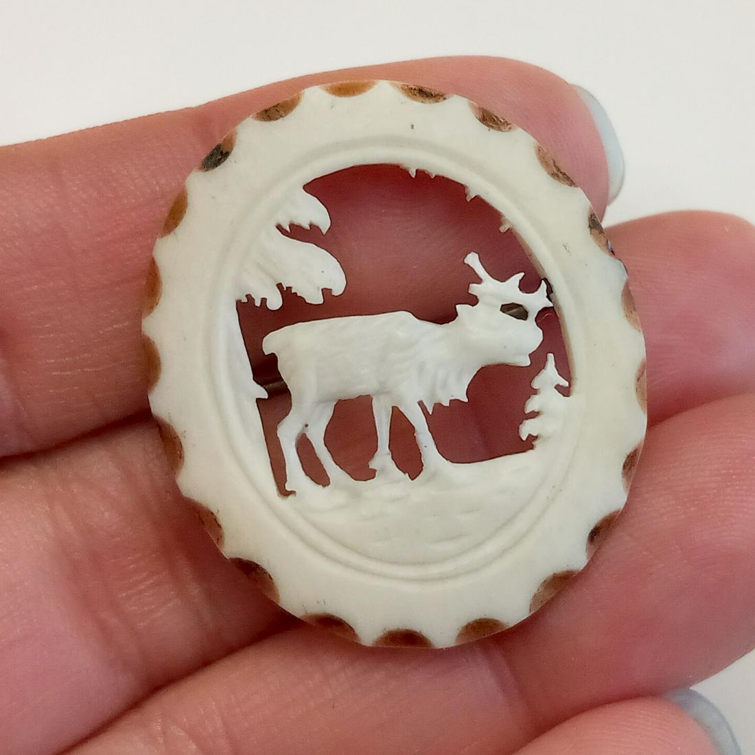 Vintage carved bone color Stag Elk Deer brooch: Vintage acrylic carved bone color, ivory color look Stag Elk Deer oval shape brooch. Measured 1 3/8 x 1 1/8 inches. Condition very good.