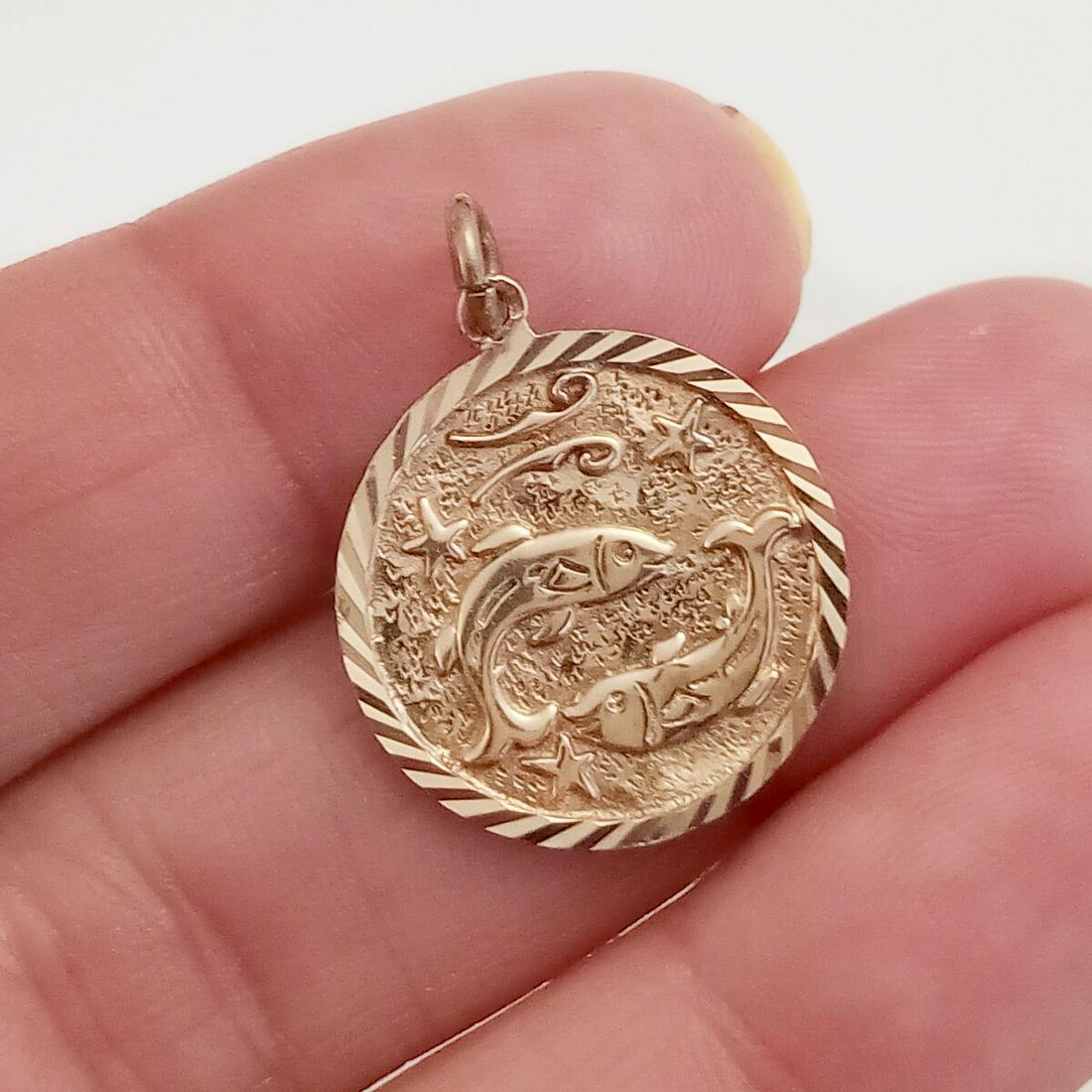 14K yellow rose gold Pisces Zodiac symbol pendant: 14K yellow rose gold Pisces Zodiac symbol pendant. Back has a ribbed textured finish. Weight 1.75 grams. Length 1 inch with bail. No hallmark, tested 14 k gold. Condition very good.