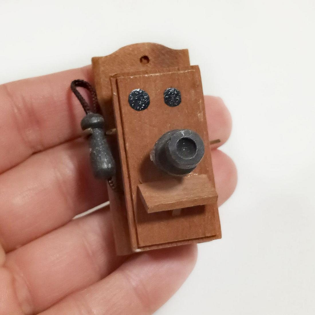 REEVESLINE 1972 brown wood antique telephone dollhouse: REEVESLINE Vintage 1972 brown wood antique style telephone dollhouse. Phone measured 1 7/8 inches in length. Sticker: ©Reevesline, reeves International Inc 1972 Copyright. Made in Japan. Condition ve
