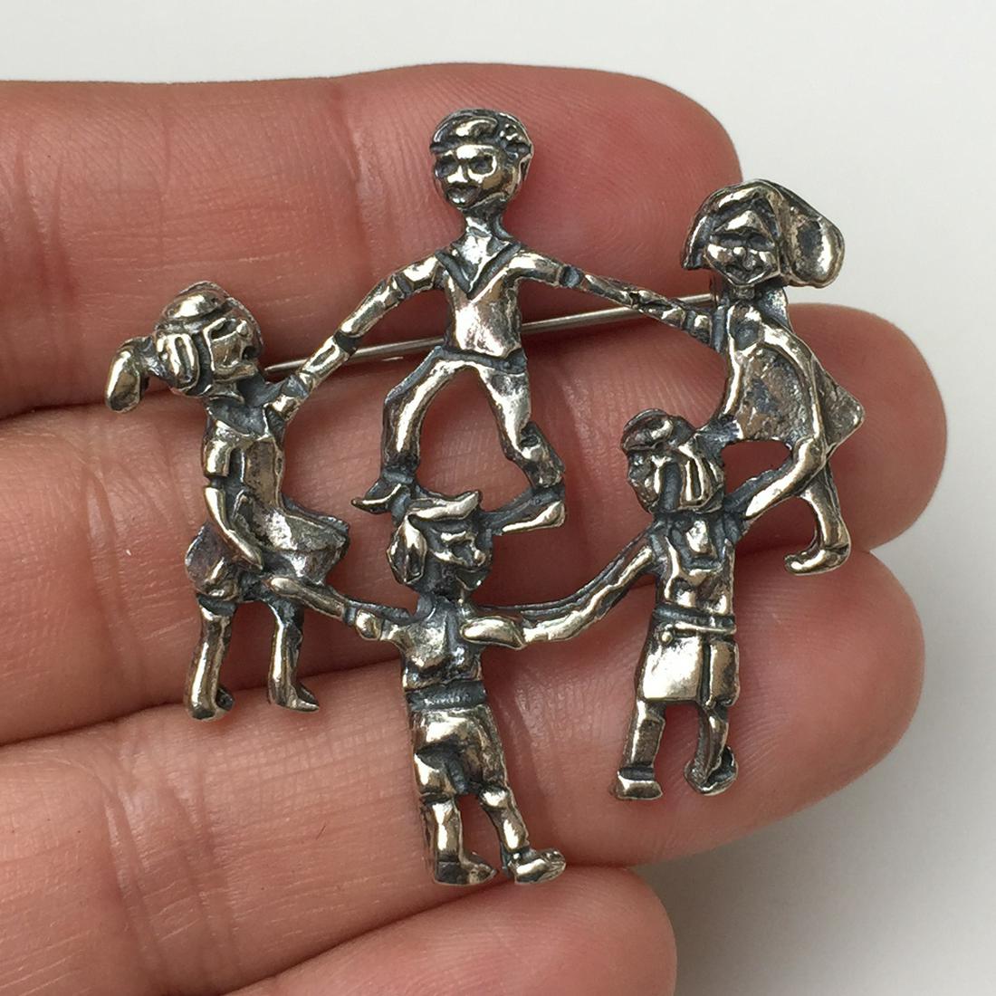 Sterling silver Children Holding Hands brooch: Sterling silver Children Holding Hands brooch. Weight 10.80 grams. Hallmarked 925. Measured 1 1/2 x 1 1/2 inches. Condition very good.