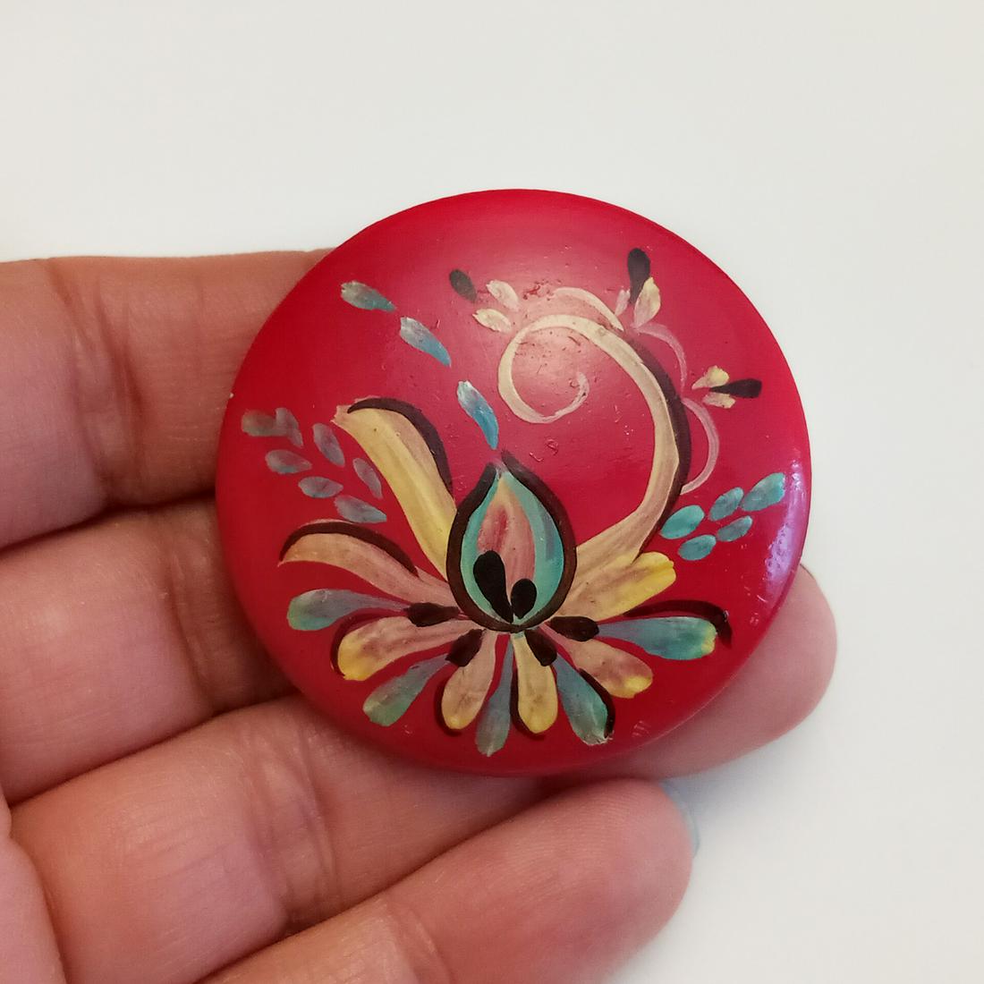 Painted wood red Flower brooch: Painted wood red Blue Ivory Flower round brooch. Measured 1 5/8 inches in diameter. Condition very good.