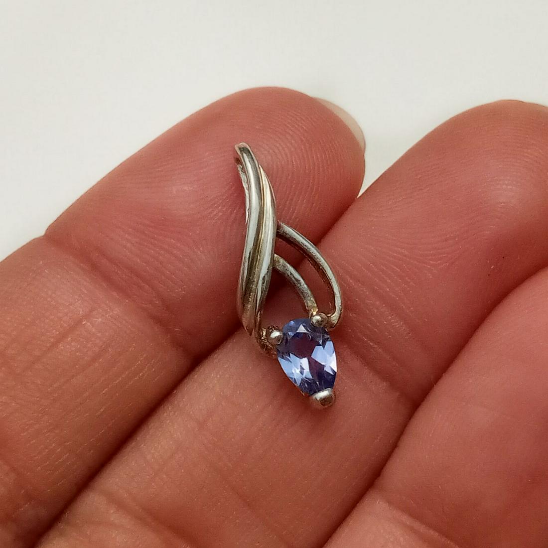 Sterling silver tanzanite color CZ pendant: Sterling silver pear shape faceted tanzanite color CZ pendant. Weight 0.97 grams. Length 7/8 inches with bail. Hallmarked UTC 925. Condition very good.