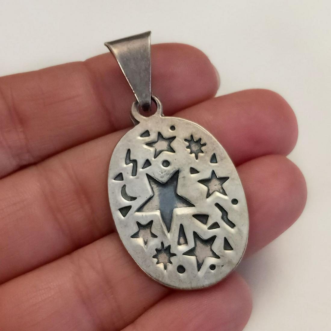 Oxidized sterling silver star accents oval pendant (1 of 3)