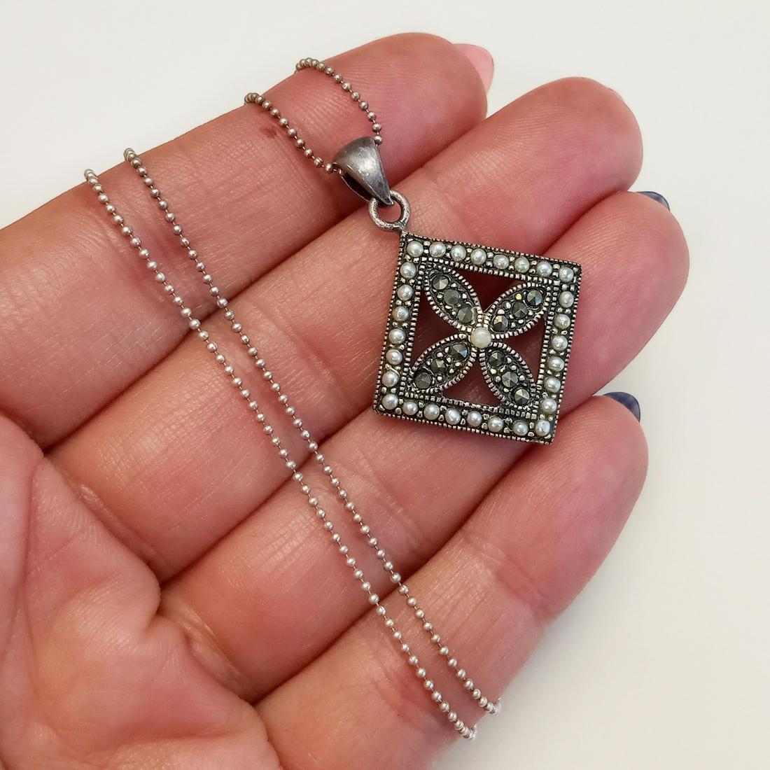 Sterling silver faux pearl marcasites pendant chain: Oxidized sterling silver tiny white faux pearls, marcasites Flower pendant and ball chain. Weight 5.29 grams. Chain length 17 1/2 inches, hallmarked 925 Italy. Pendant length 1 3/8 inches, hallmarked 