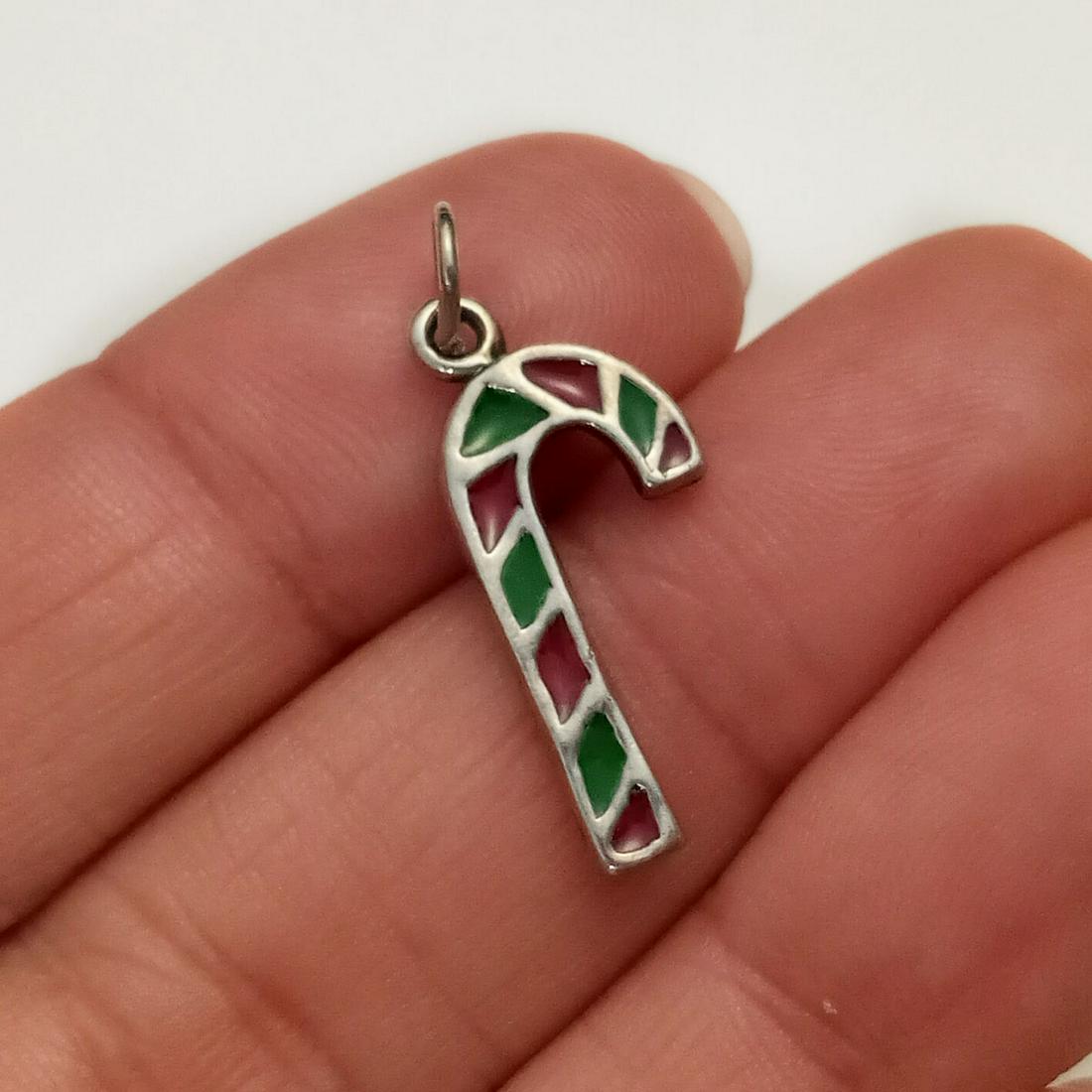 Vintage sterling silver enamel Candy Cane charm: Vintage sterling silver red and green enamel Candy Cane charm pendant. Weight 1.59 grams. Length 1 inch with bail. Hallmarked 925, maker's logo. Condition very good.