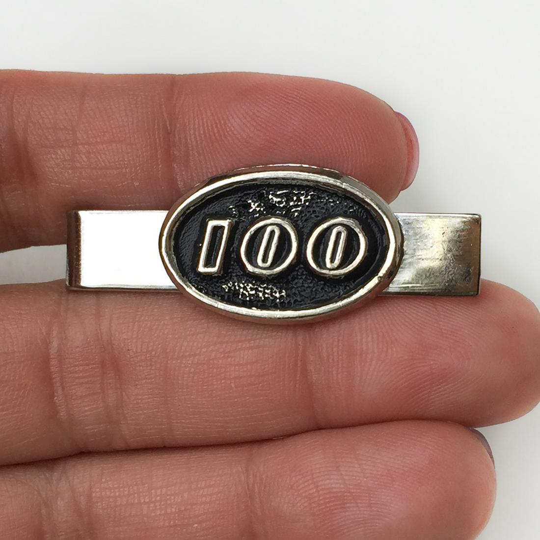 Silver and black tone "100" tie bar clip: Silver and black tone "100" tie bar clip. Measured 1 3/4 inches. Condition very good.