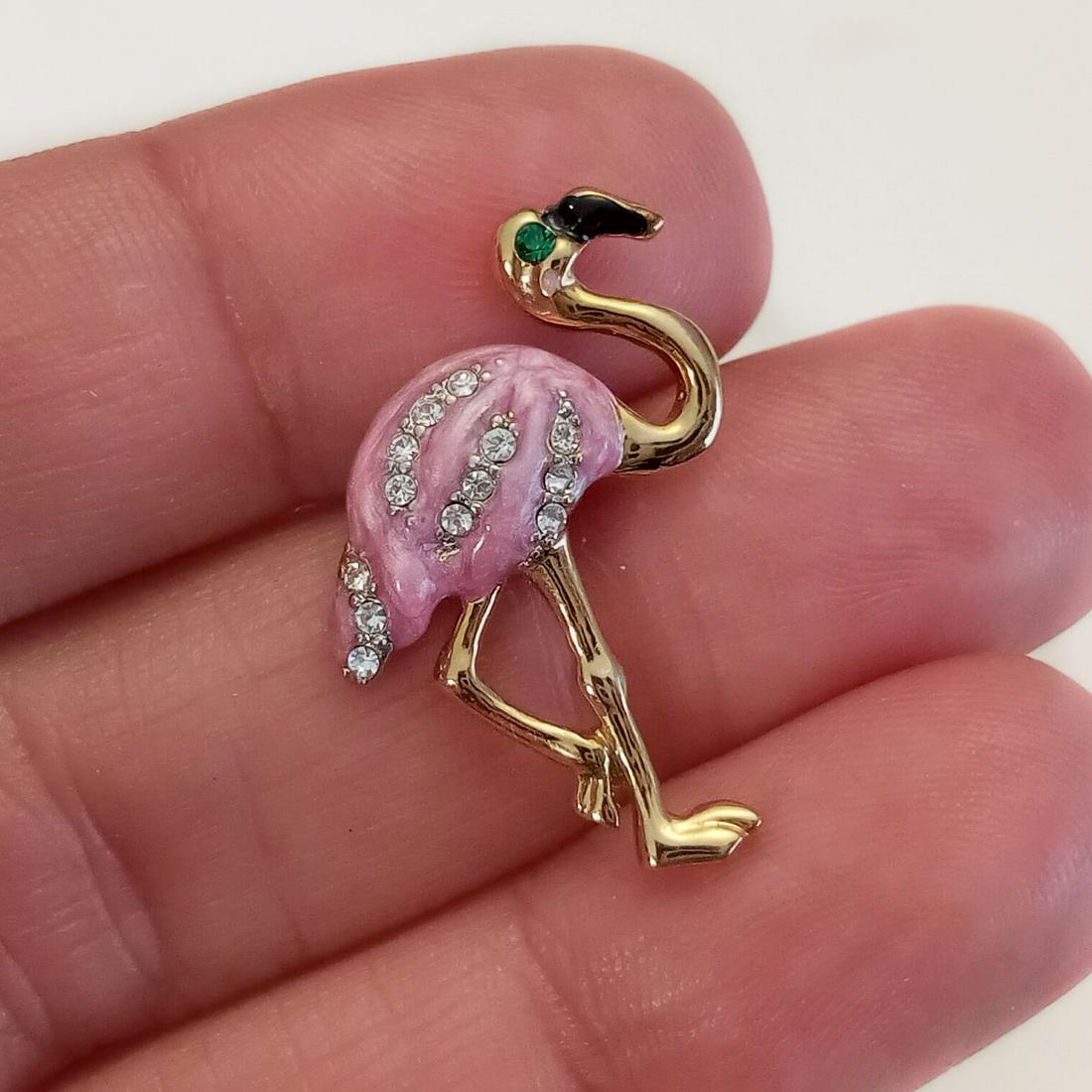 Vintage gold tone rhinestones pink Flamingo bird brooch: Vintage gold tone clear rhinestones and pink enamel Flamingo bird brooch. Measured 1 x 3/4 inches. Condition very good.