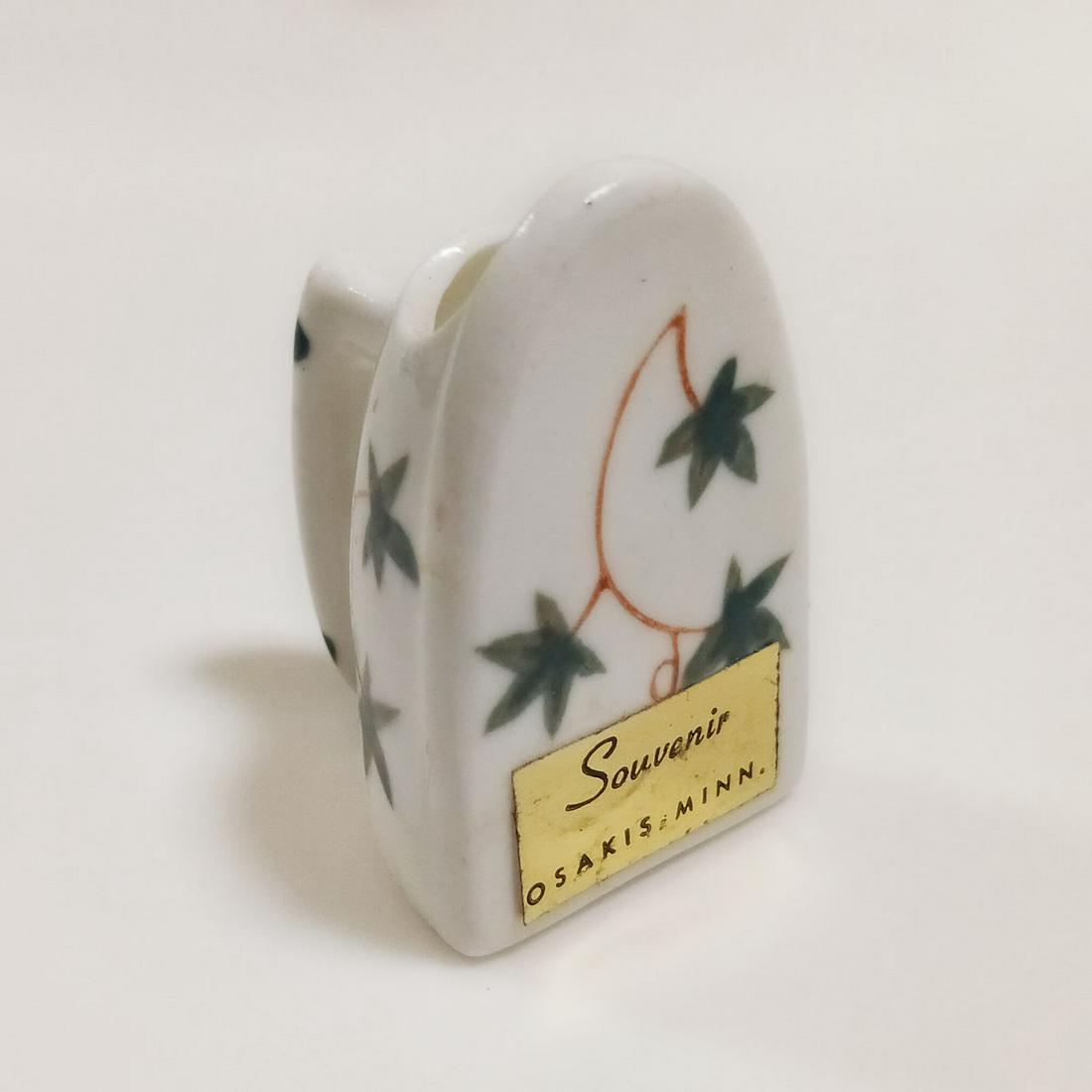 BRADLEY Souvenir Osakis Minn. Bone China vase holder: BRADLEY Souvenir Osakis Minn. Bone China white with leaves and vines design vase toothpick holder. Measured 2 1/8 inches in height, 1 1/4 x 1 1/2 inches. Bradley Bone China, Japan. Condition very good