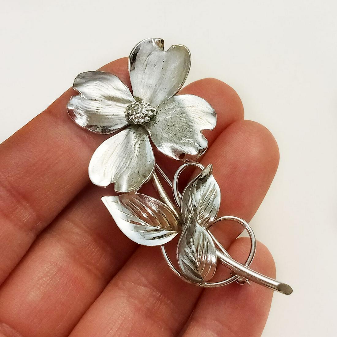 HARRY S BICK Vintage sterling silver Flower brooch: HARRY S BICK Vintage sterling silver matte and shiny finish Flower brooch, signed. Weight 7.3 grams. Measured 2 1/4 x 1 1/8 inches. Hallmarked Sterling HSB. Condition very good.