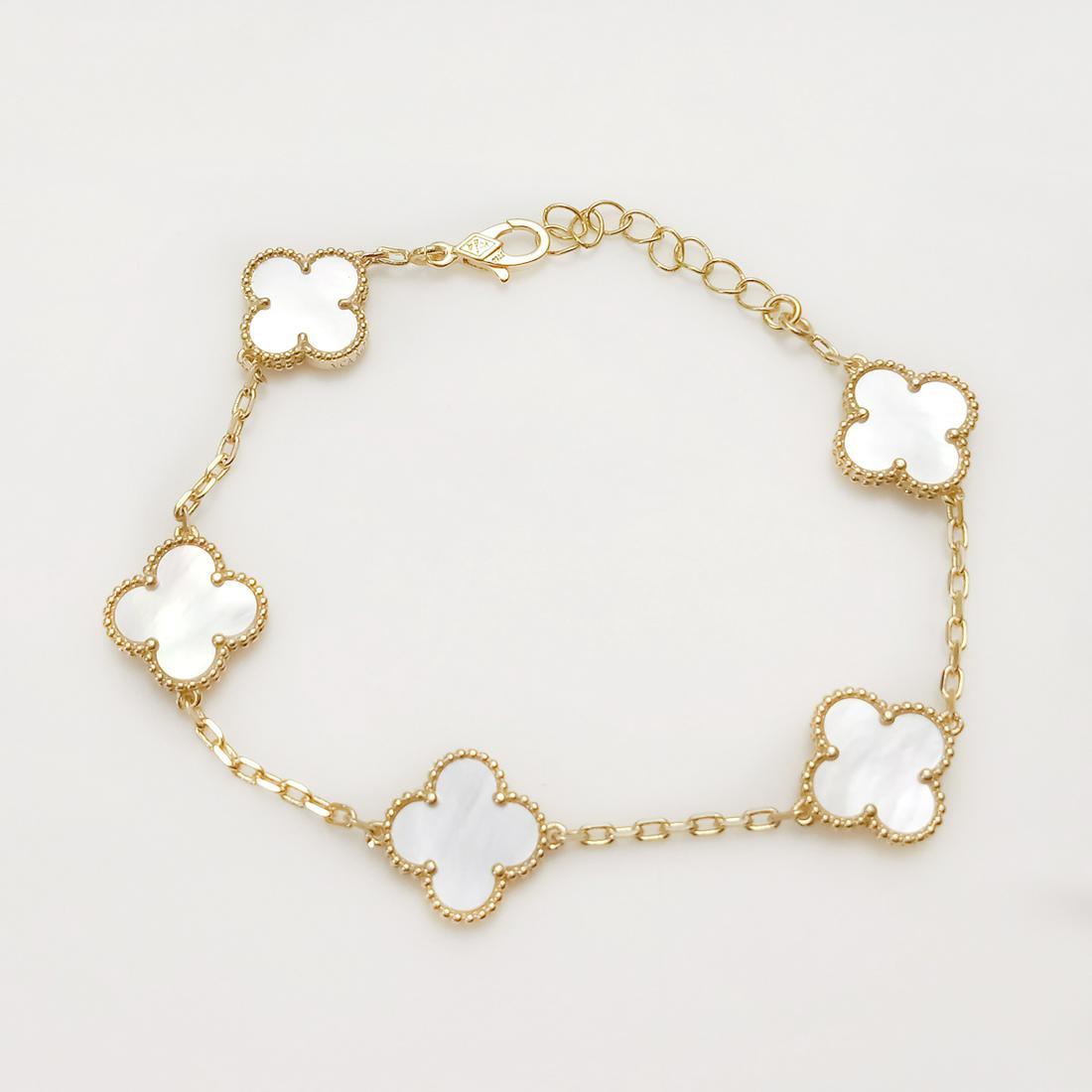 Gold tone stainless steel white MOP color 4 Leaf Clover Flowers bracelet: Gold tone stainless steel textured finish white mother of pearl color 4 Leaf Clover Flowers bracelet. Length 7 1/2 inches + 1 1/2 inches extender. Clover flowers are double sided and measured approxim