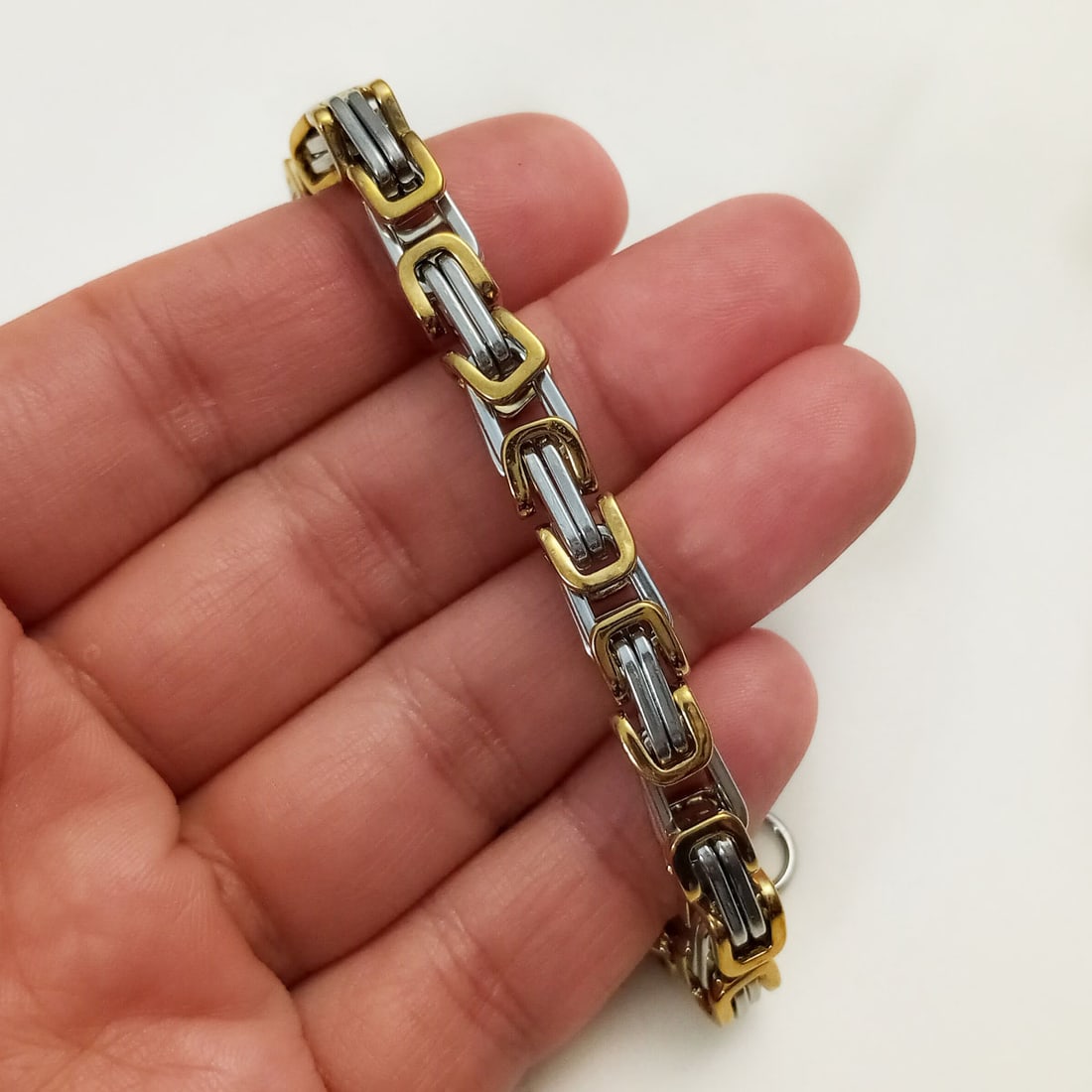 Two tone stainless steel fancy chain bracelet: Two tone stainless steel fancy chain bracelet, 8 3/4 inches. Length 8 3/4 inches. Width measured 1/4 inches. Bracelet is heavy and feels like stainless steel. Condition excellent.