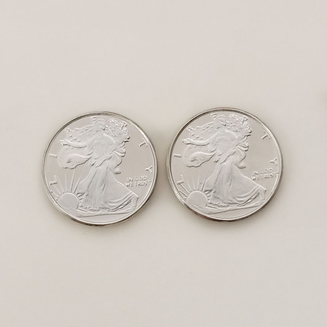 Lot of 2 US Walking Liberty 1/10 oz Fine silver rounds: Lot of 2 Collectible United States Walking Liberty American Eagle 1/10 troy oz .999 Fine Silver rounds bullions. Each is: 1/10 .999 fine silver, 18 mm round. Pure silver 1/10 oz Walking Liberty Rounds