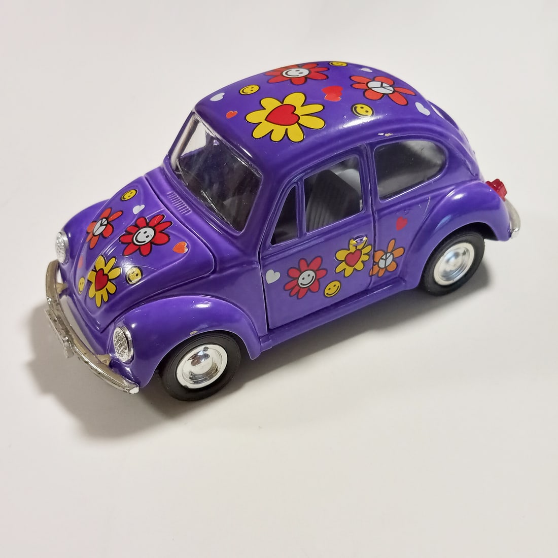 Purple flower Volswagen Bug pull back die cast car: Purple flower VW Volswagen Bug pull back die cast car SS5702. Doors and hood opens. Measured 5 1/8 x 2 3/8 x 2 1/4 inches. Condition very good.