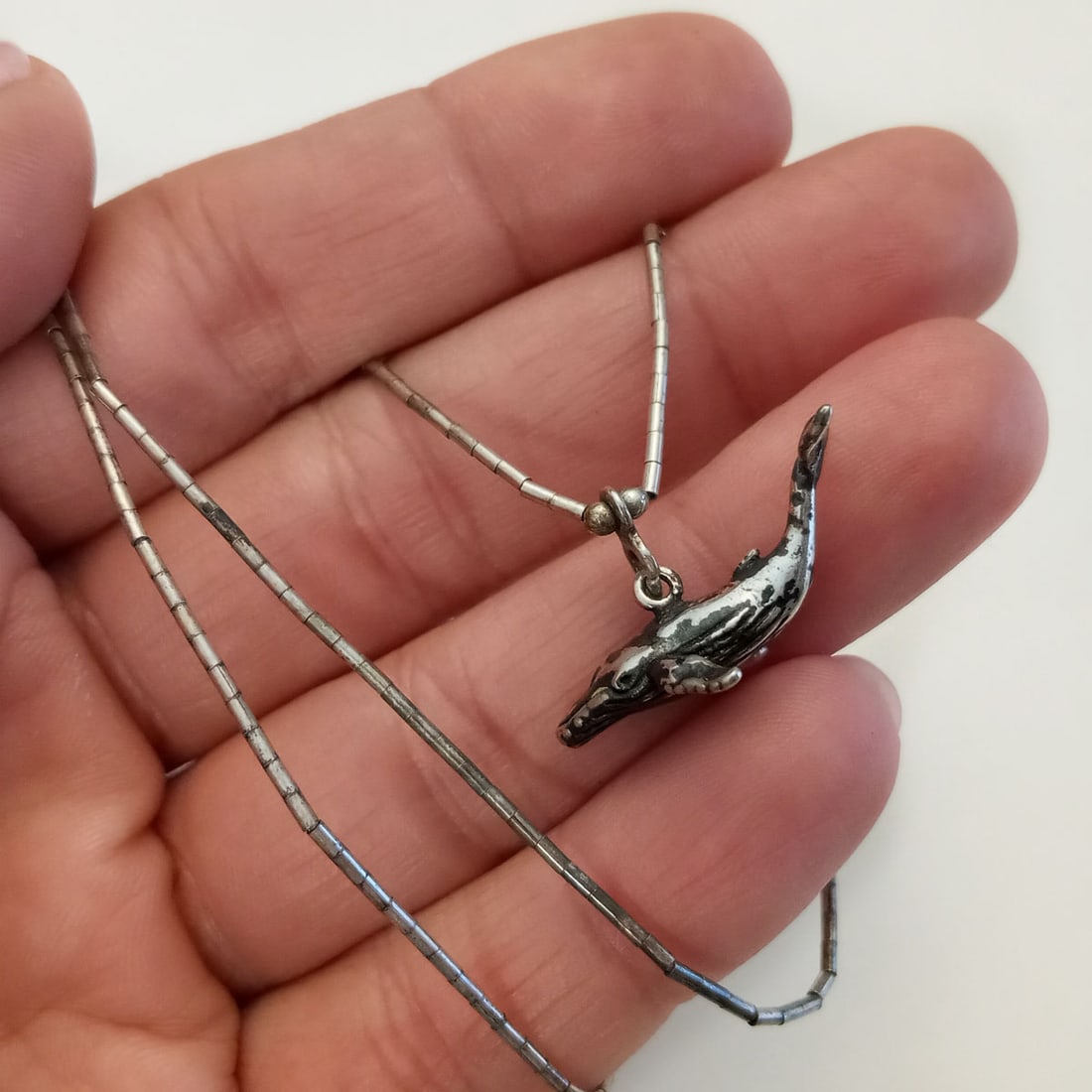 Sterling silver Whale pendant tube chain necklace: Oxidized sterling silver Whale pendant charm and tube beads chain necklace. Weight 5.48 grams. Pendant measured 1/2 x 1 inches with bail, hallmarked 925 and maker's logo. Chain length 17 1/4 inches, h