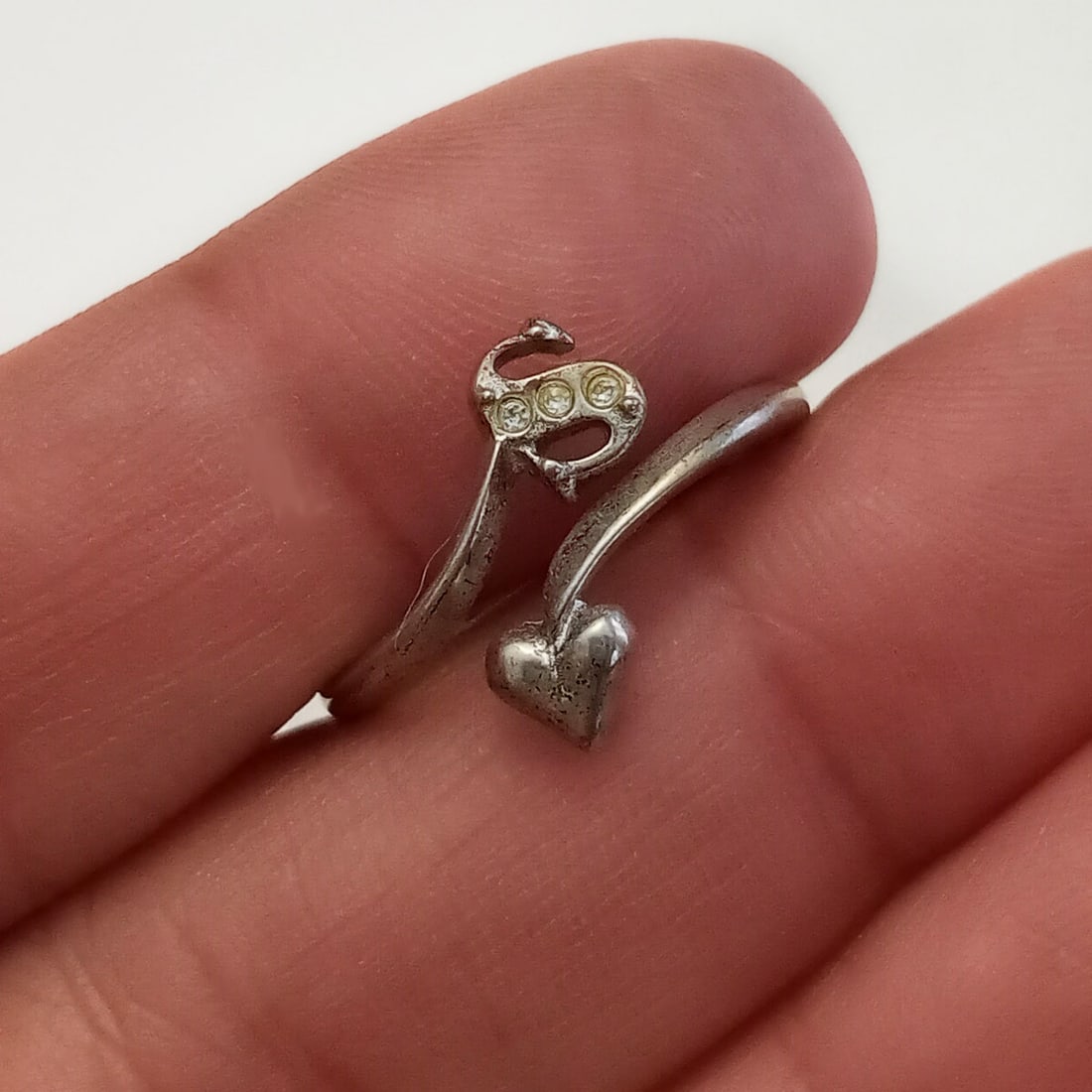 AVON Sterling silver S heart rhinestones ring 5-6 1/2: AVON Sterling silver letter Initial S heart clear rhinestones ring size 5 - 6 1/2. Weight 2 grams. Hallmarked Avon 925. Condition good.