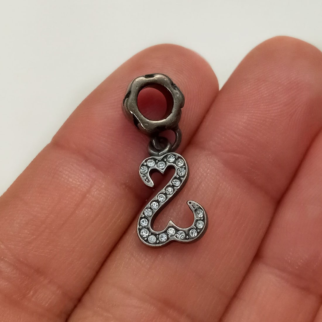 Sterling silver clear rhinestones open hearts charm: Oxidized sterling silver clear rhinestones open hearts charm. Weight 2.09 grams. Length 1 inch. Hallmarked MA, 925 Italy. Condition very good.